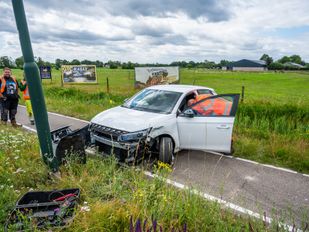 Auto eindigt op fietspad na botsing tegen lantaarnpaal
