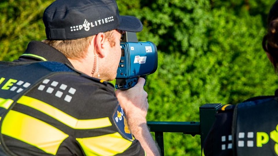 Agent met lasergun controleert de snelheid