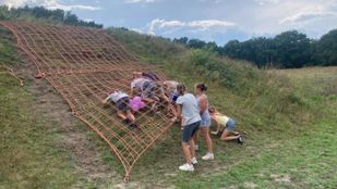 Groepje jongeren tijgert onder net door op stormbaanhelling