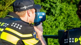 Agent met snelheidsmeter op viaduct